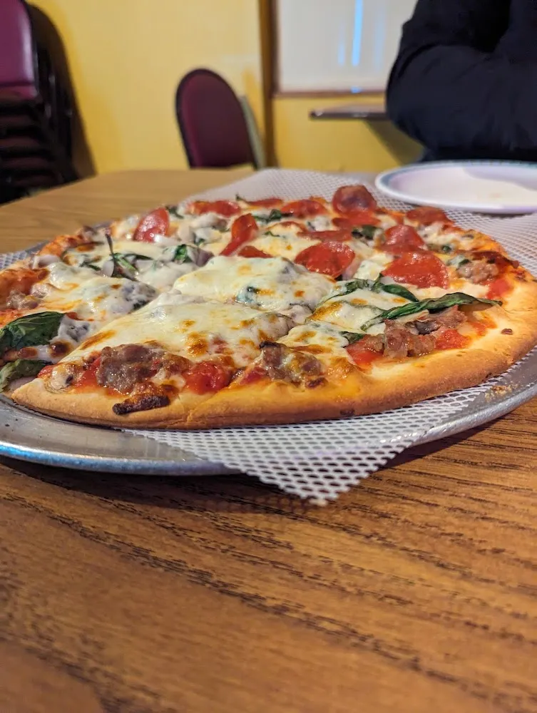 Half Sausage Spinach Mushrooms and Onions and Half with Added Pepperoni